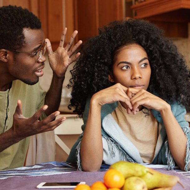 people relationships concept African American couple arguing kitchen man glasses gesturing anger despair scream